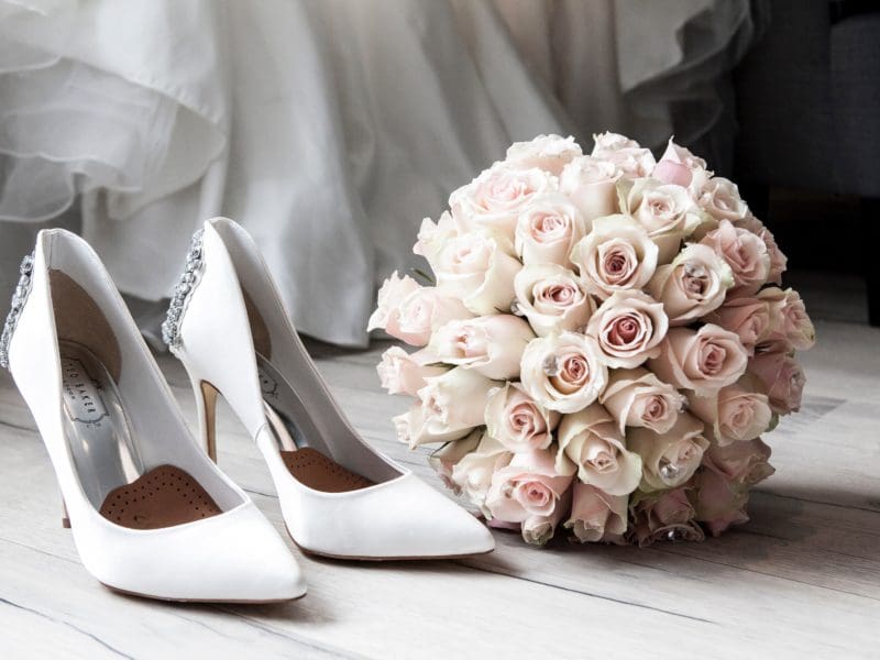 bridal shoes and rose bouquet