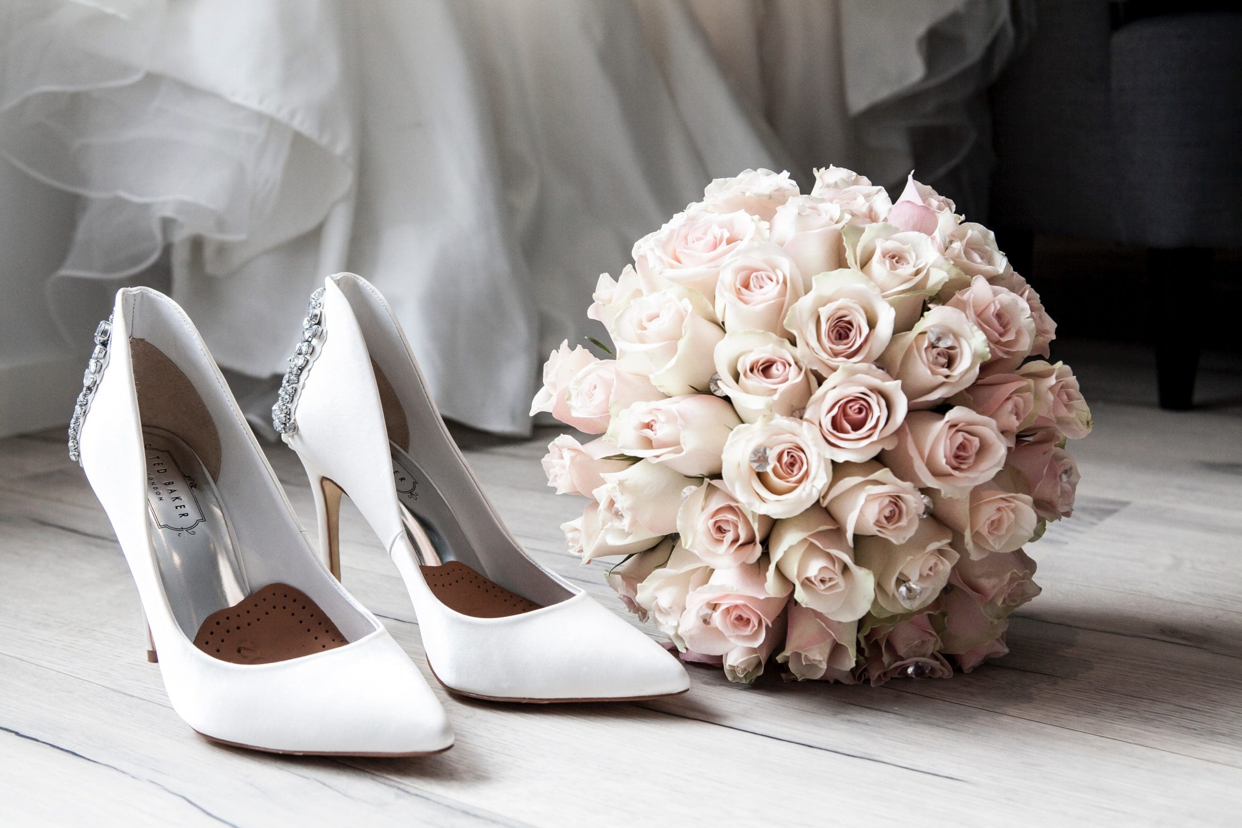 bridal shoes and rose bouquet