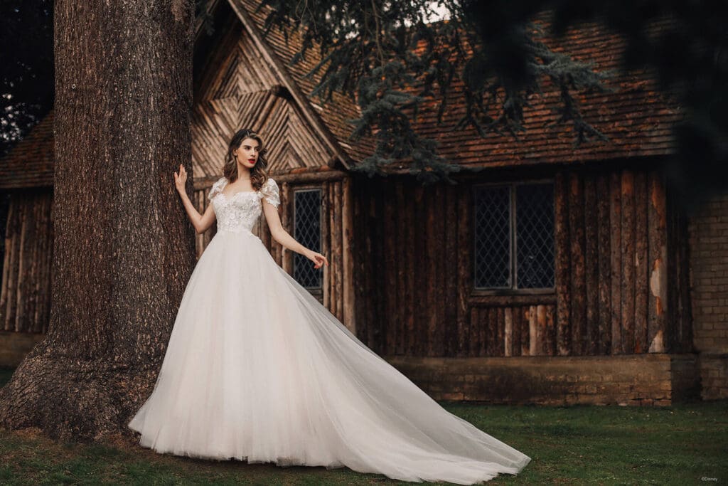 woman wearing long white mermaid bridal gown in the forest
